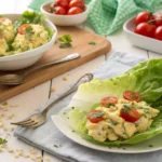 The Best Keto Deviled Egg Salad – Creamy & Low-Carb! 8 Keto deviled egg salad served in lettuce wraps with cherry tomatoes.