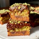 Brown Butter Dubai Pistachio Chocolate Chip Cookie Bars stacked with melted chocolate and kataifi crunch