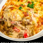 Keto Philly cheesesteak casserole baked with bell peppers, onions, and melted provolone cheese in a white baking dish