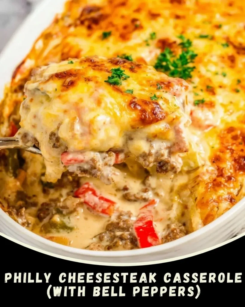Keto Philly cheesesteak casserole baked with bell peppers, onions, and melted provolone cheese in a white baking dish
