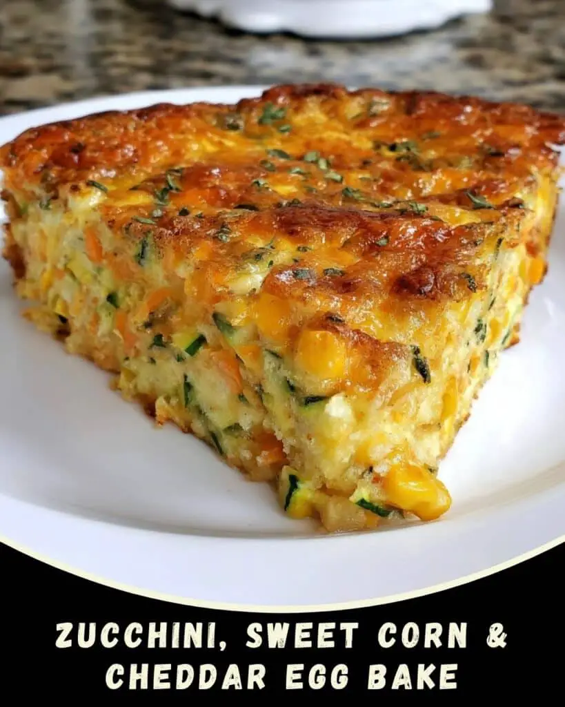 Slice of golden-brown zucchini, sweet corn, and cheddar egg bake on a white plate